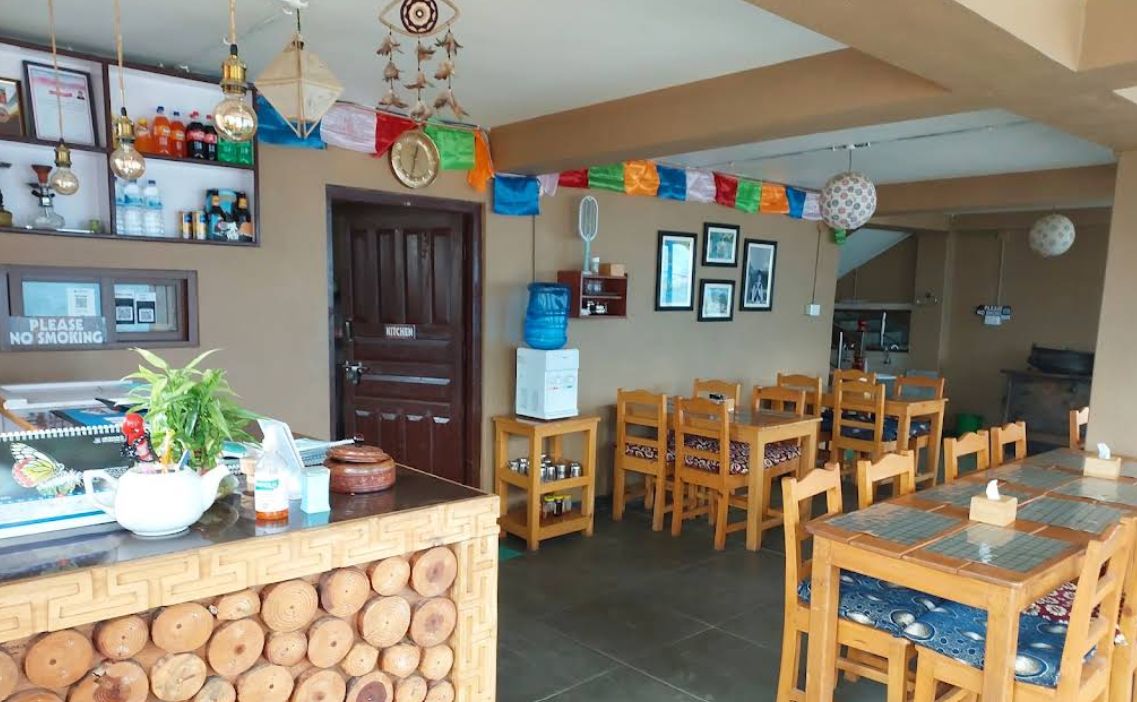 The colourful dining room with prayer flag bunting
